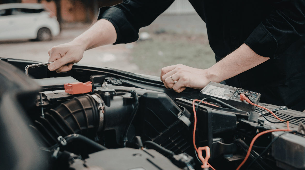 Person jump starting car battery